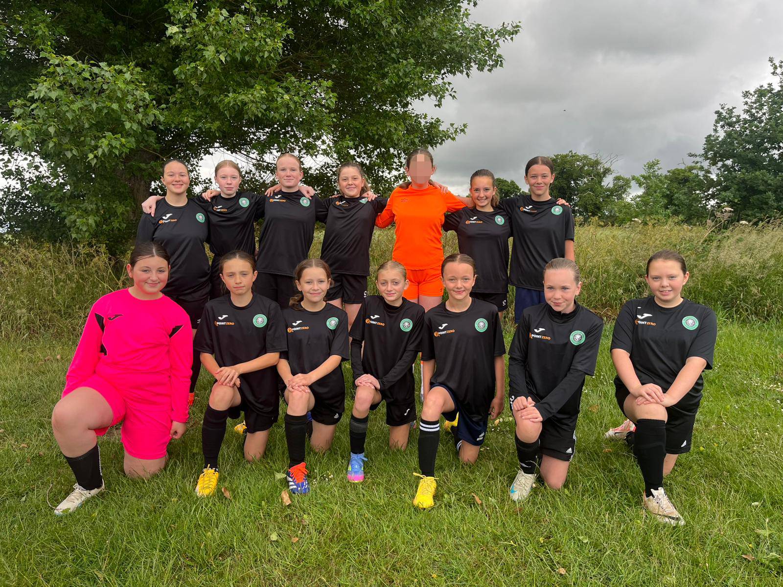 U13 team stand in a line with their arms around each other